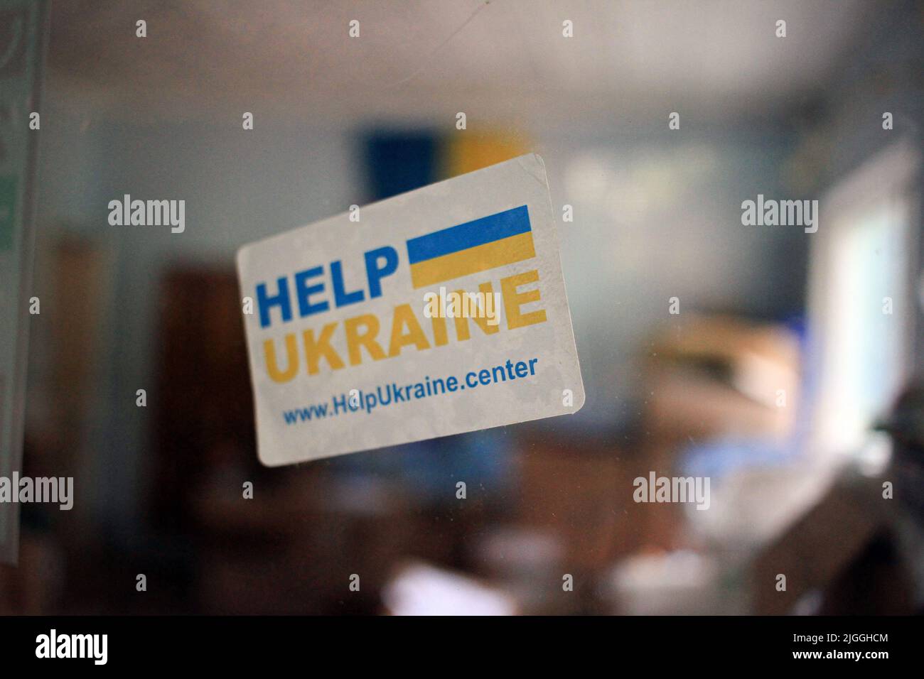 Odessa, Ukraine. 24th May, 2022. A sticker reading 'Help Ukraine' is visible on the door. Previously, the building was used for extracurricular education of children in creativity and biology. Since the beginning of the war between Russia and Ukraine, a volunteer center has been operating in these premises, dealing with the distribution of humanitarian aid from EU. (Photo by Viacheslav Onyshchenko/SOPA Images/Sipa USA) Credit: Sipa USA/Alamy Live News Stock Photo