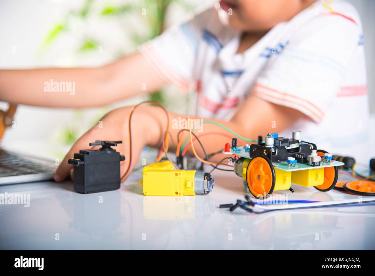 Asian kid boy learns coding and programming with laptop for Arduino ...