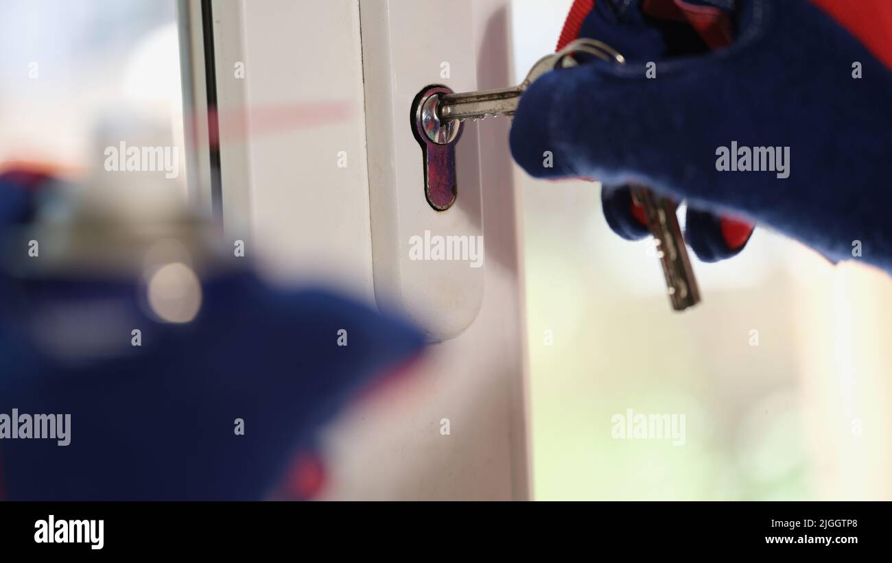 Repairman checking keys and lock of plastic window Stock Photo Alamy