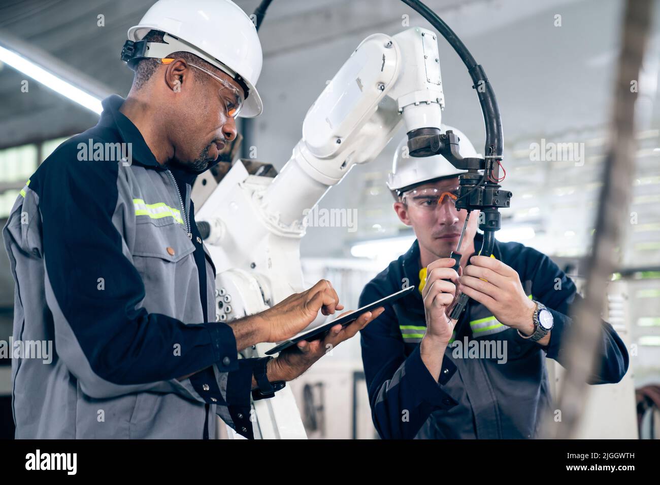 Factory workers working with adept robotic arm in a workshop . Industry robot  programming software for automated manufacturing technology Stock Photo -  Alamy