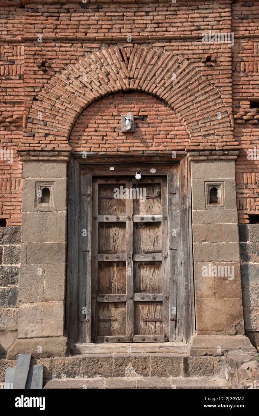 Old brickwork construction, Wooden Door, Darvaja, Beautiful Brick Pattern, Wafgaon, Taluka Khed, Dist Pune Stock Photo