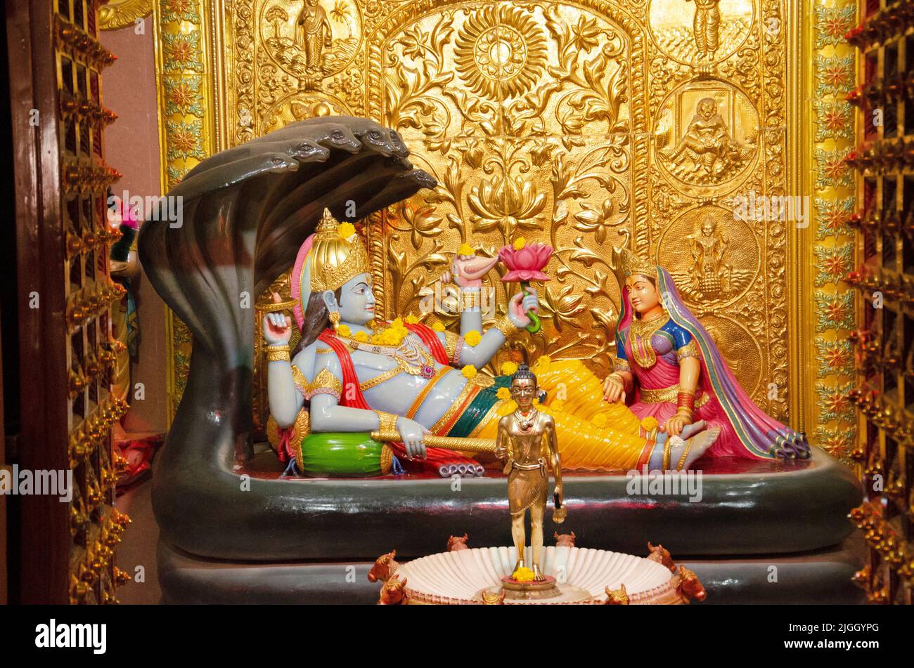 Colourful idol of Lord Vishnu at Nilkanthdham, an extensive religious complex with pagodas, fountains, statues & carved idols and gates, located at Po Stock Photo