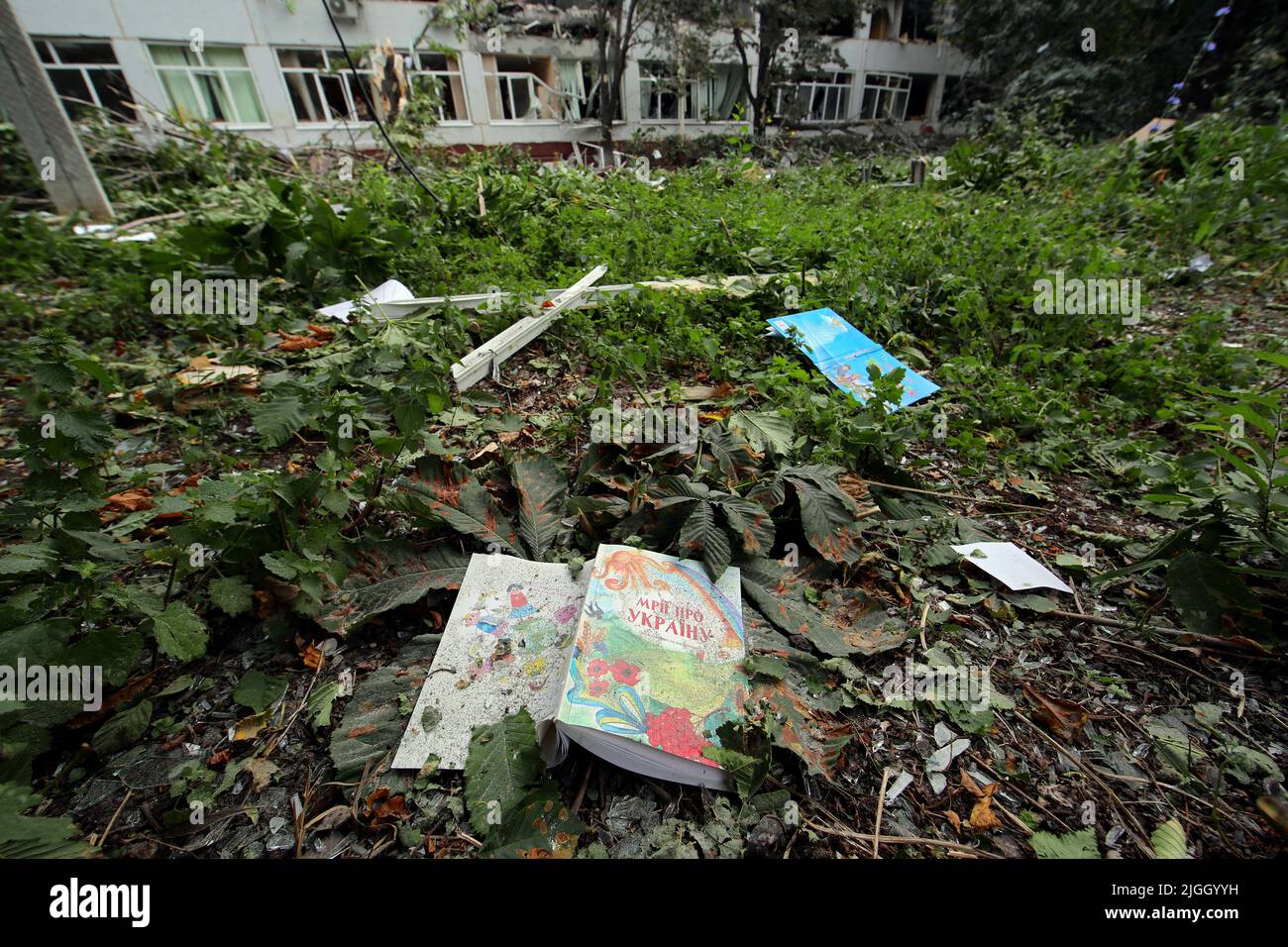 KHARKIV, UKRAINE - JULY 10, 2022 - Textbooks are scattered on the premises of a gymnasium destroyed in shelling by Russian troops, Kharkiv, northeaste Stock Photo