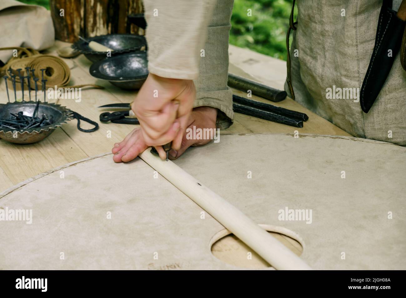 Making medieval shields made of wood and leather to protect soldiers in