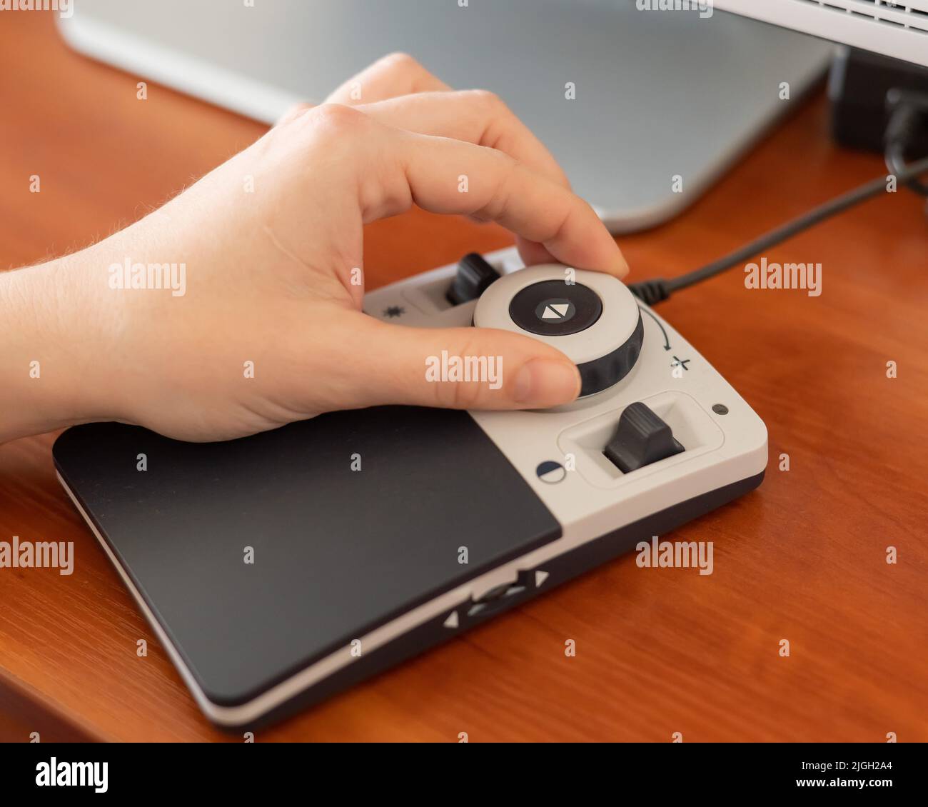 A woman uses a special magnification device for the visually impaired