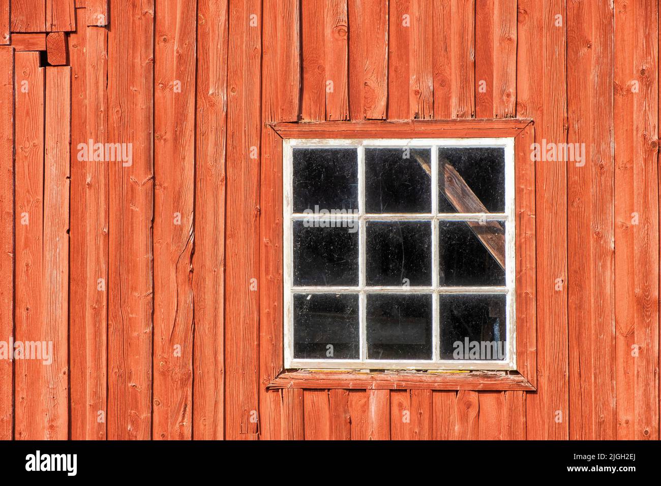 Red weathered barn with a window Stock Photo