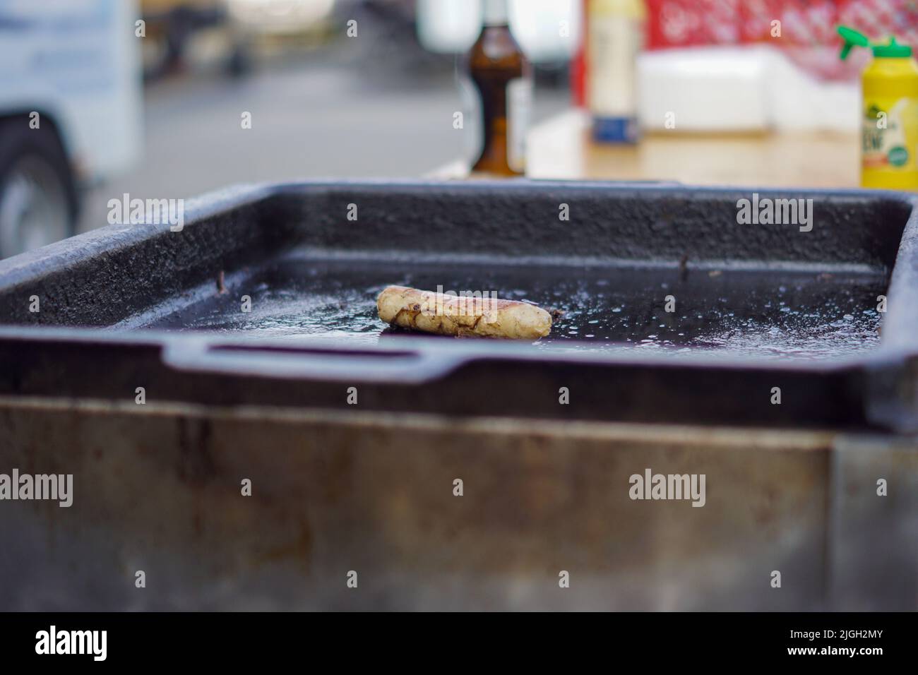 Sausage on a steel plate Stock Photo
