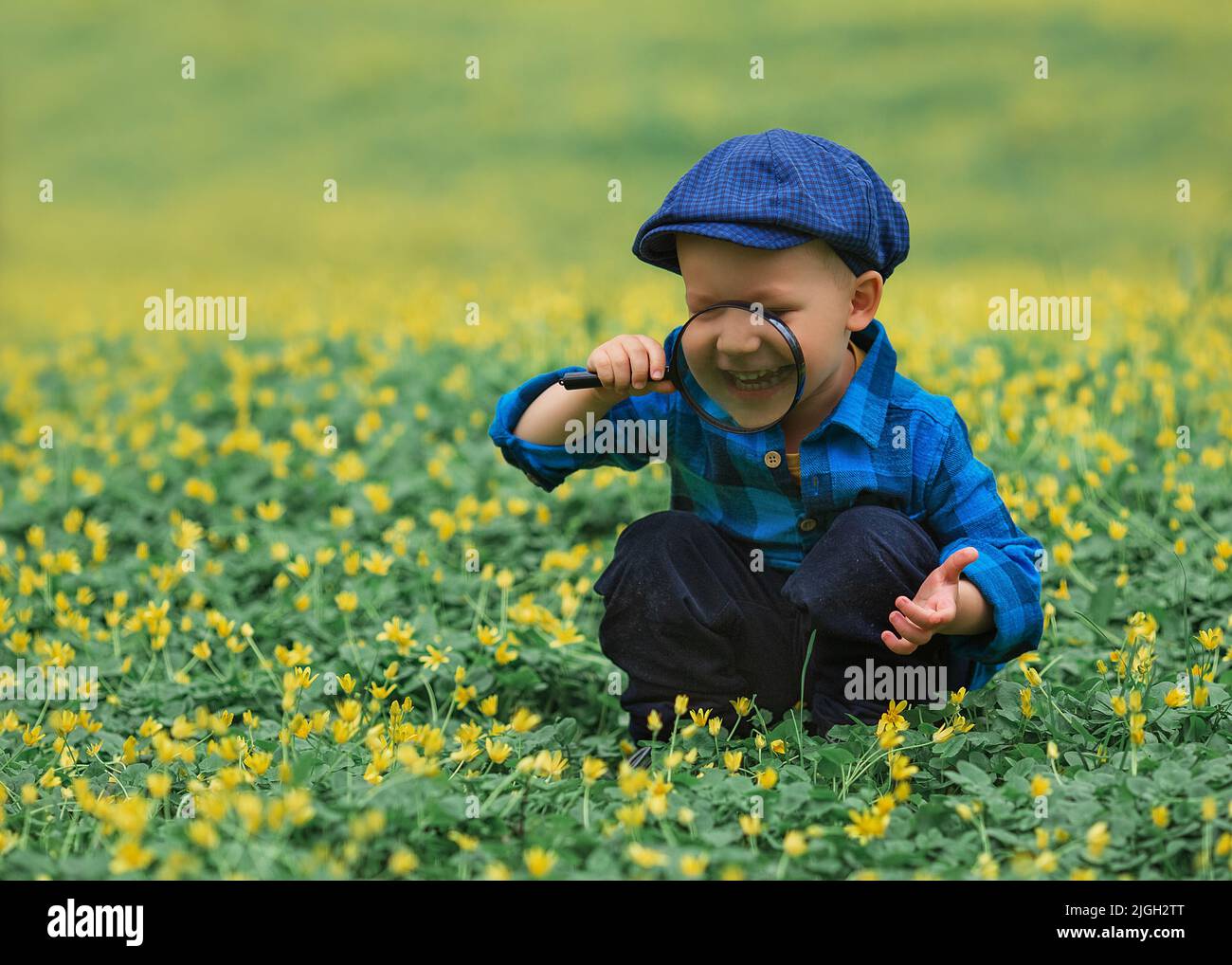 Happy little happy child boy, exploring nature with magnifying glass ...