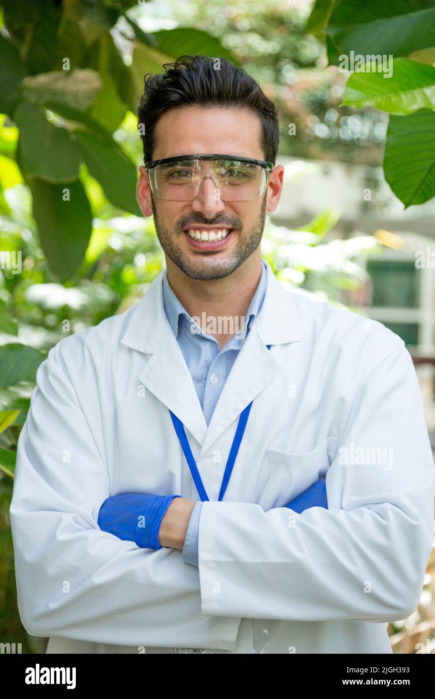 Vertical portrait of a biologist in uniform and protective gear in a