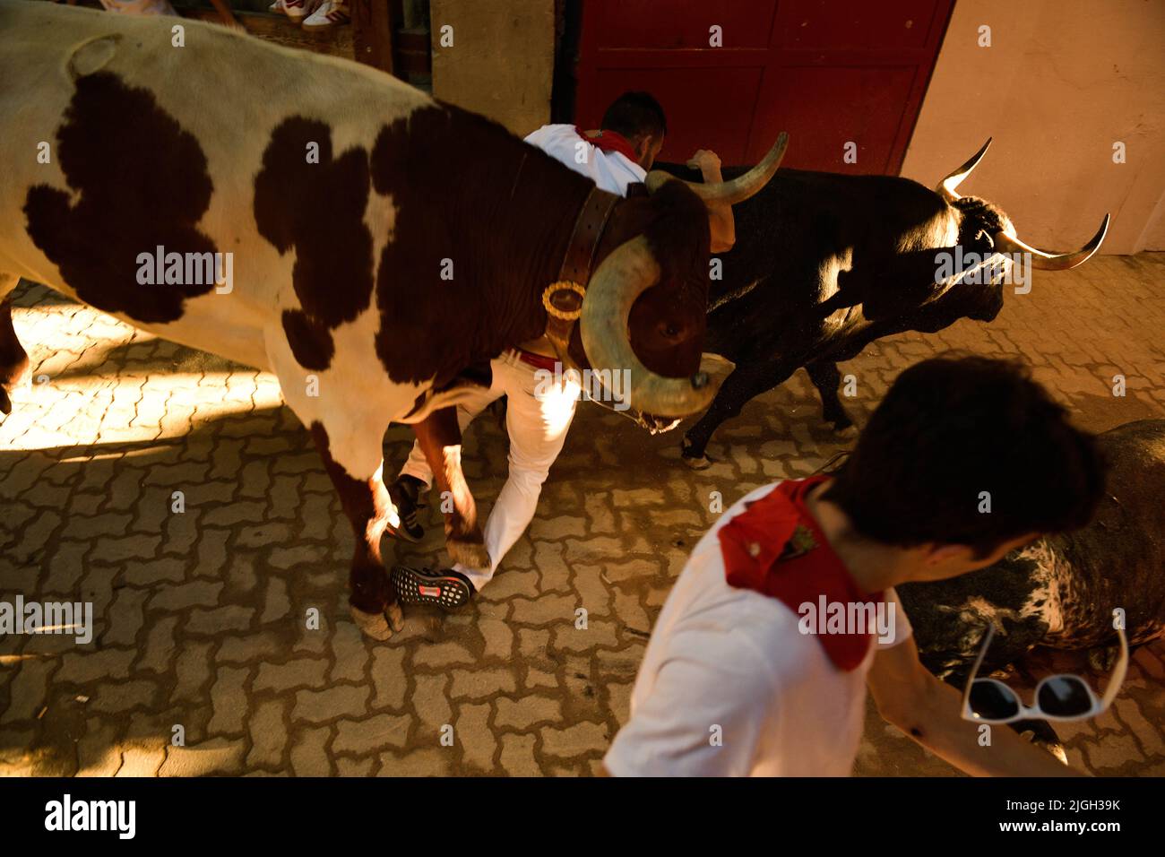 Pamplona, Spain. 11th July, 2022. Runners fall during the running of the  bulls at the San
