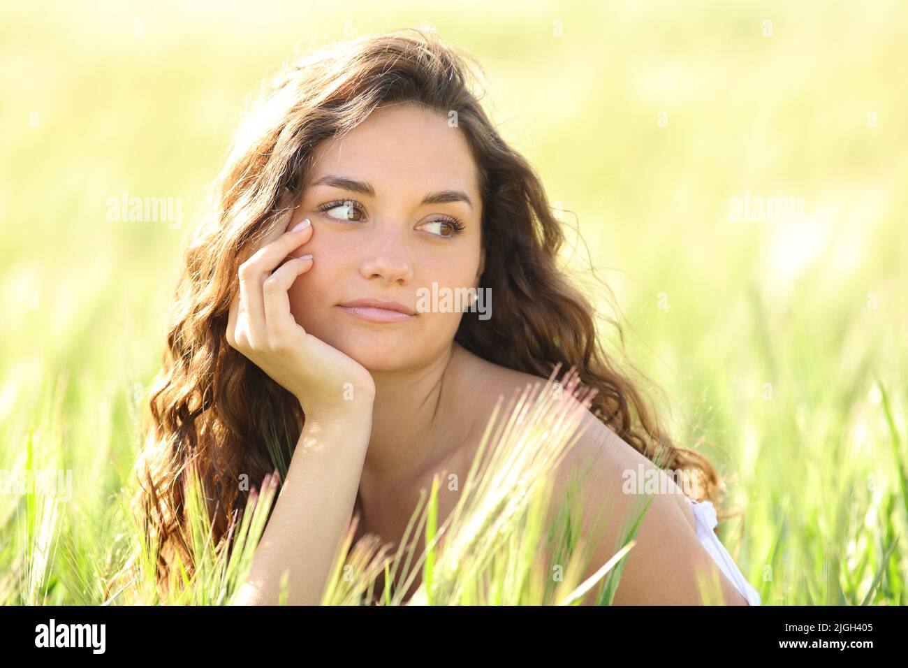 Portrait of a beautiful woman looking at side in a wheat field Stock Photo