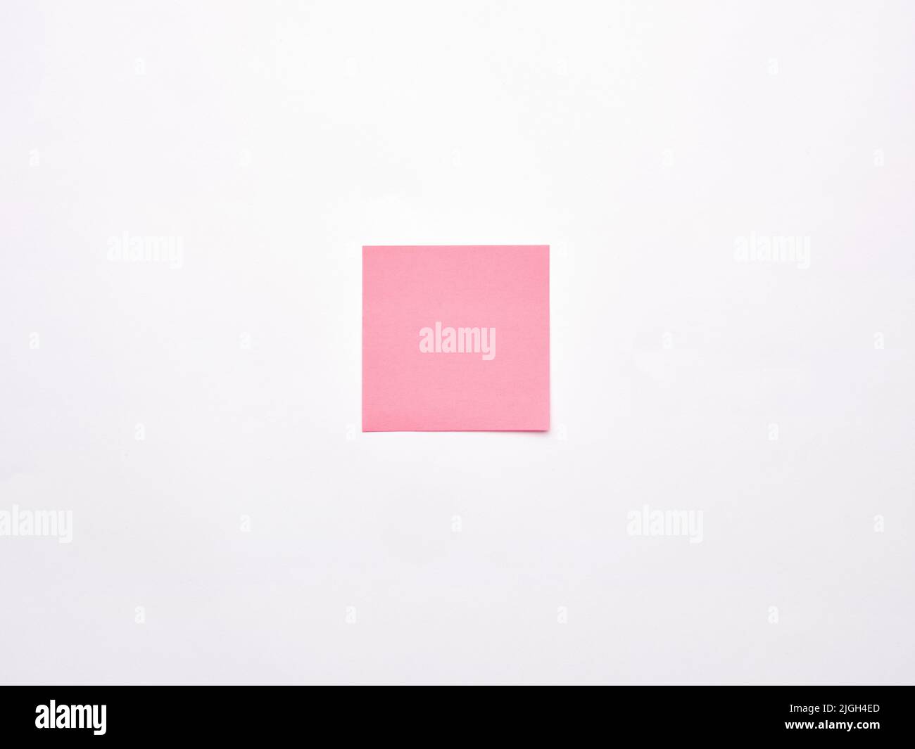Blank or empty pink notepaper or notepad on white background. Stock Photo