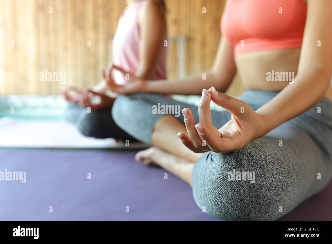 Close up of two women hands doing yoga in spa Stock Photo