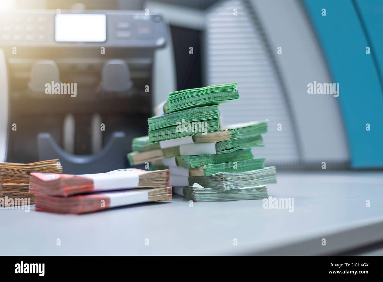 Large amounts of money in the bank. Bank employees sorting and counting