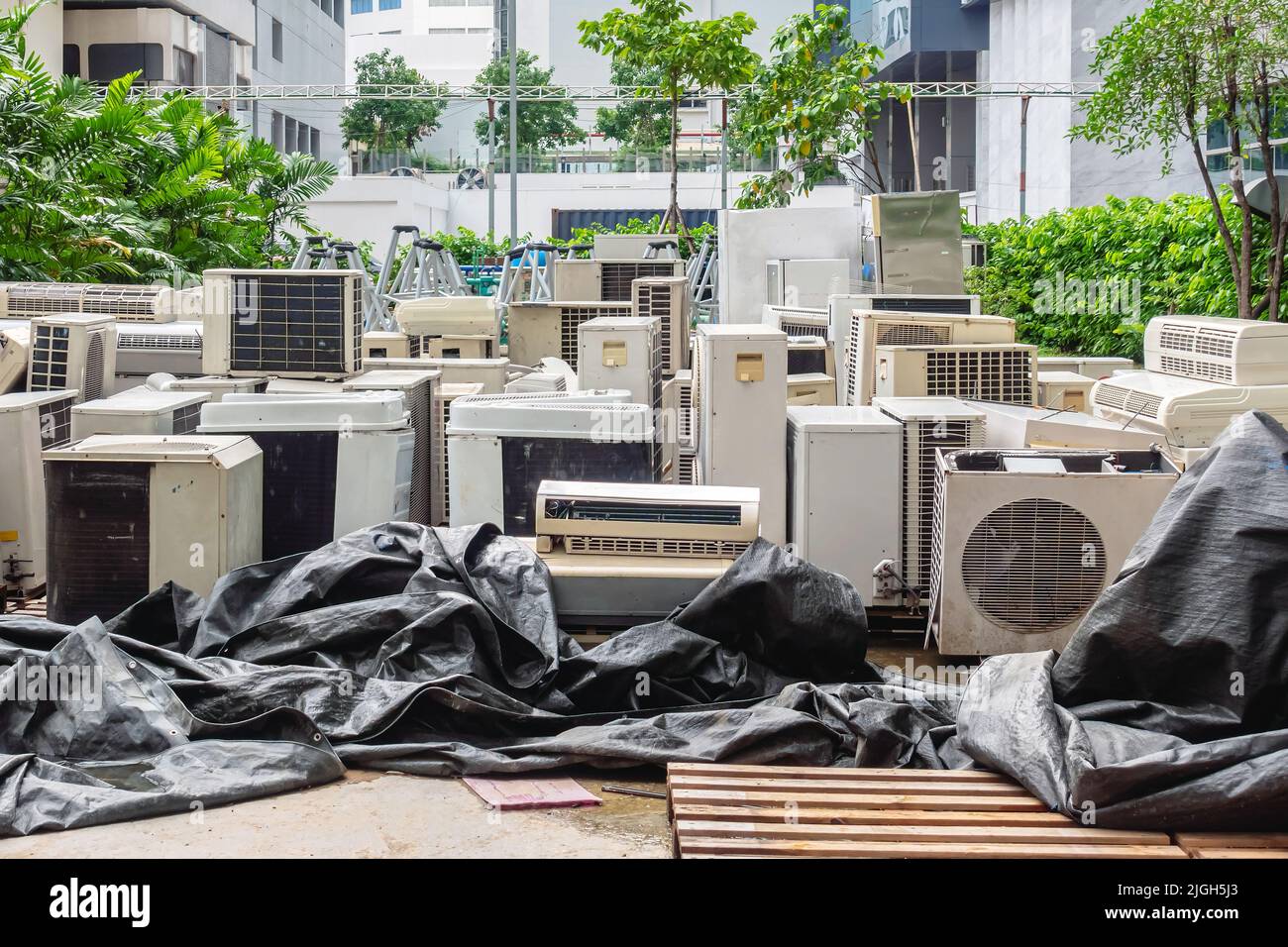 A lot of Air conditioners stacked up in a pile to disposal at recycling