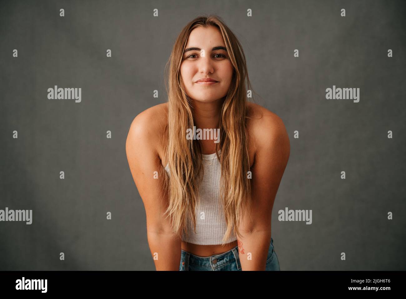 Close up Caucasian female long blond hair smiling in casual wear Stock Photo