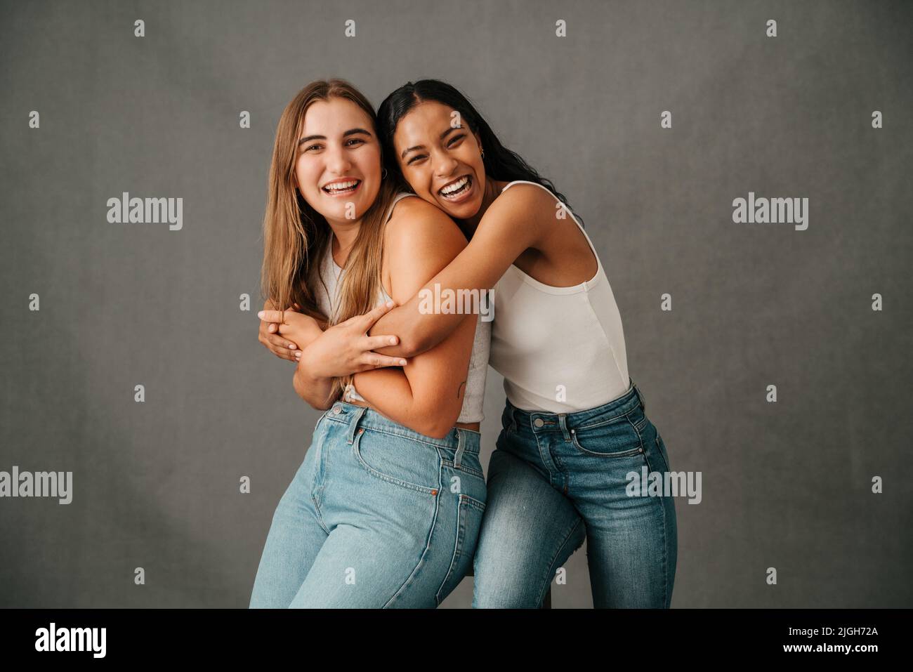 Two female friends hugging and laughing and just having fun Stock Photo