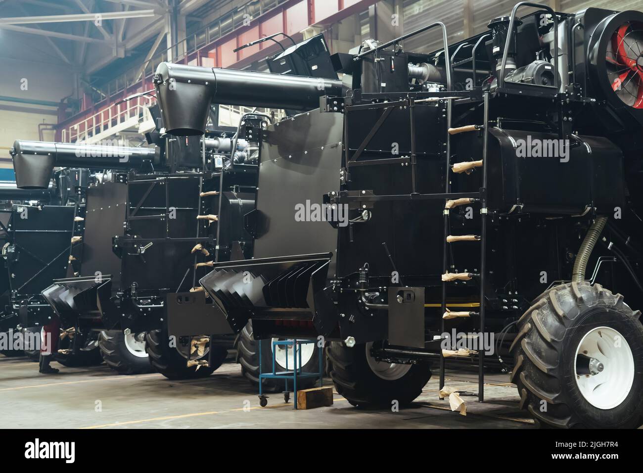 Factory hangar with combine harvesters assembled. Industrial production of agricultural machinery. Stock Photo