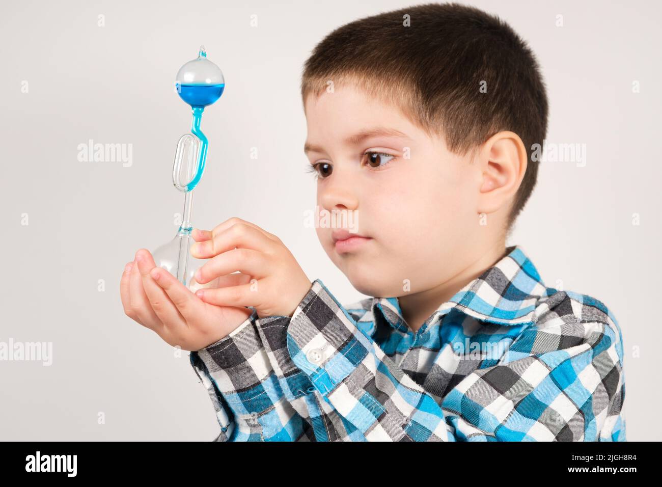 a-4-year-old-boy-is-studying-chemistry-holding-in-his-hand-a-flask