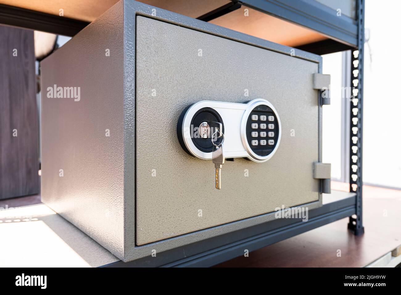 Cash Money safe deposit box. a metal safe and a key in the lock Stock