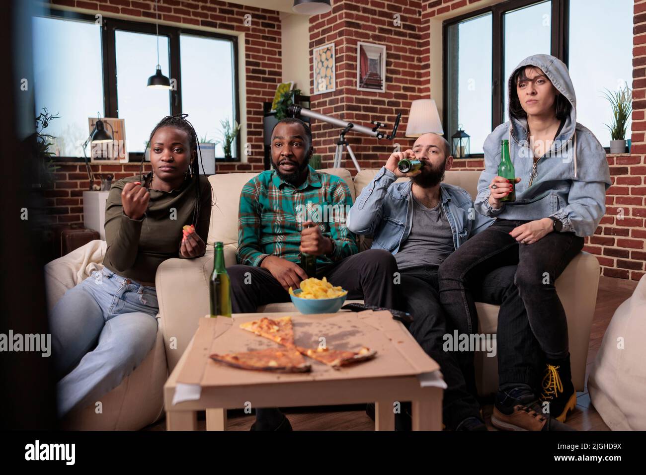 Diverse group of sport fans watching football match game, drinking