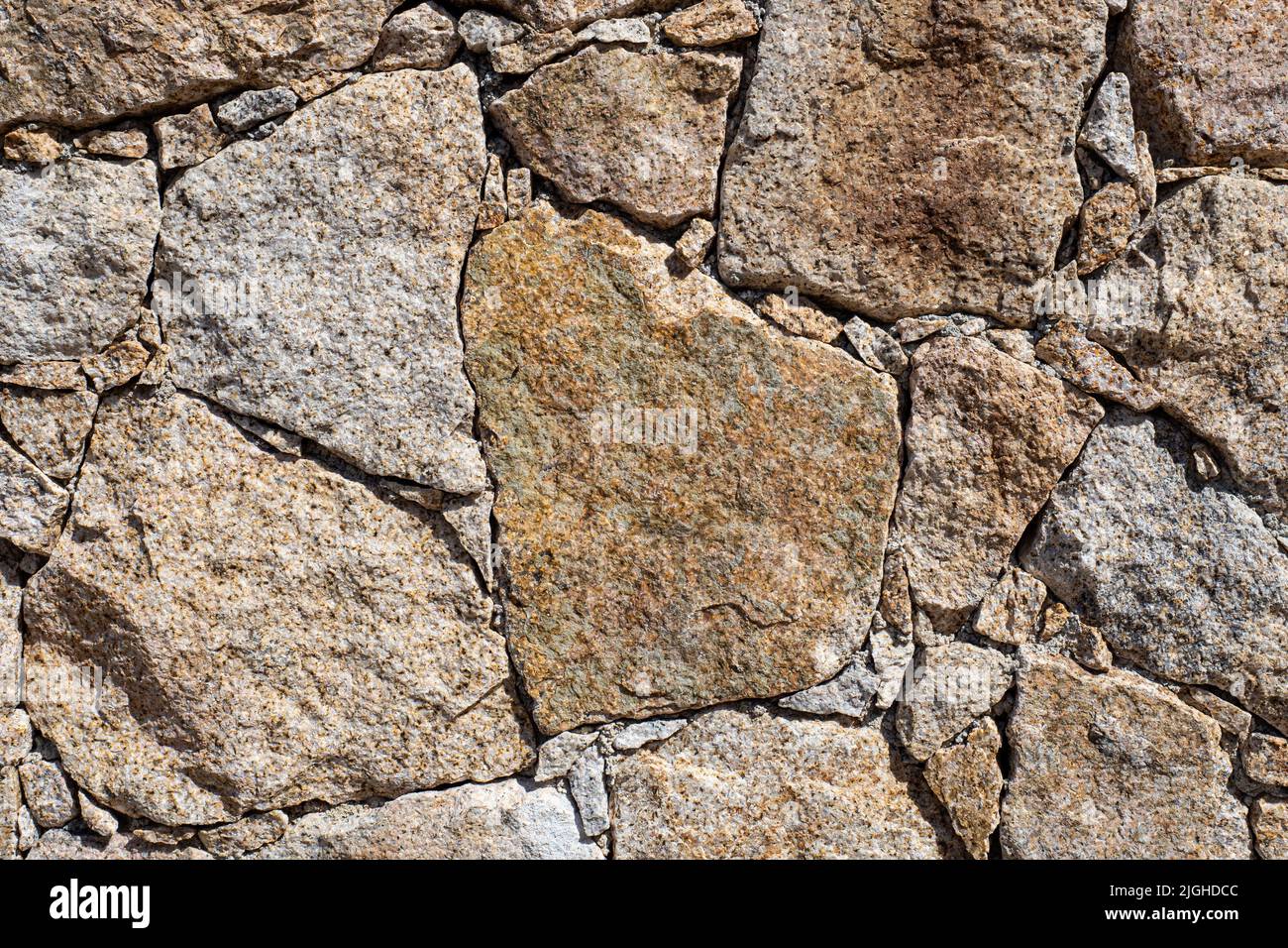 Close-up of a house wall made of  granite stones on the mediterranean island of Corsica Stock Photo