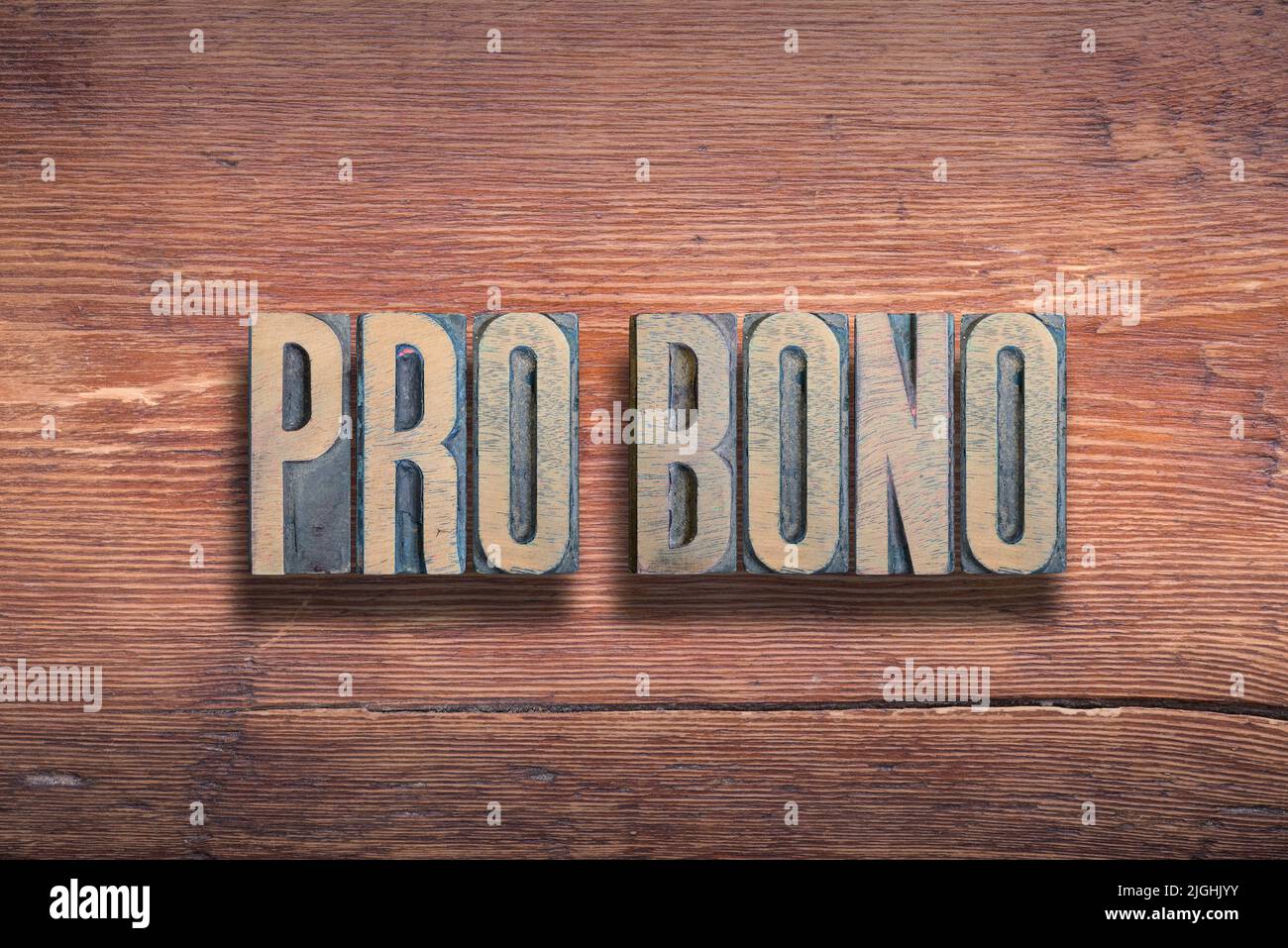 pro bono ancient Latin saying meaning - for the public good, combined on vintage varnished wooden surface Stock Photo