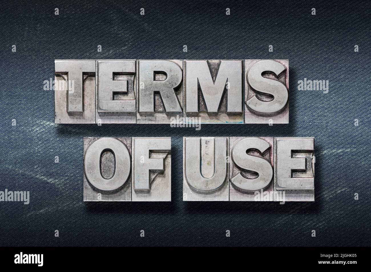 terms of use phrase made from metallic letterpress on dark jeans background Stock Photo