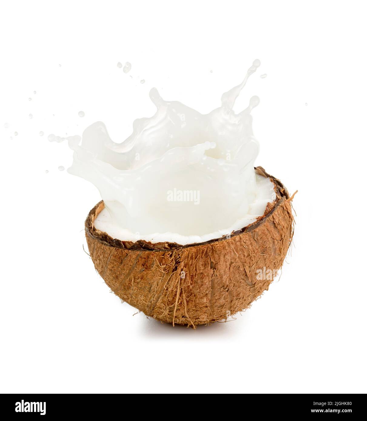 coconut milk spilling out of an half fruit Stock Photo Alamy