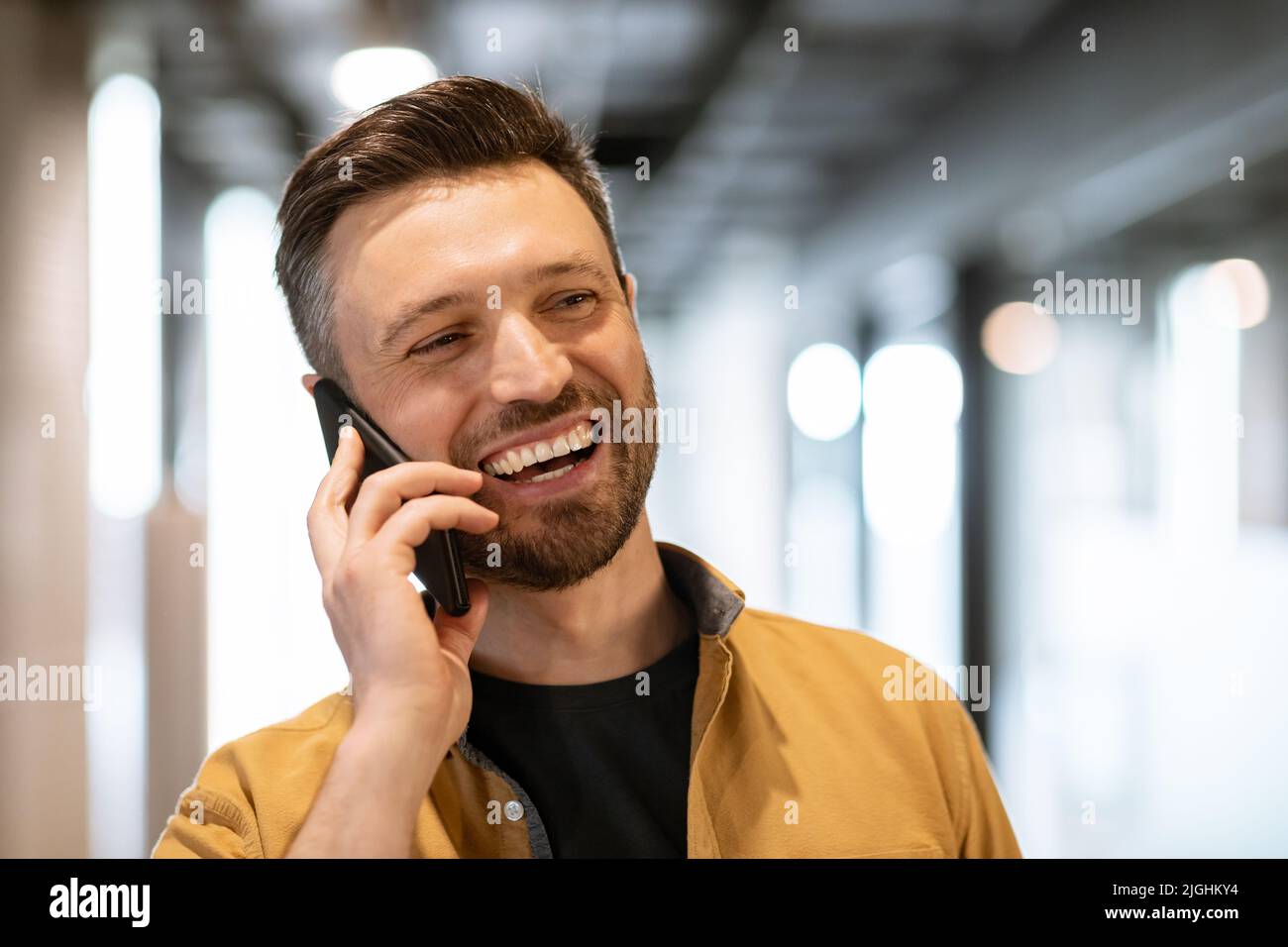 Smiling Business Man Talking On Phone Communicating At Workplace Stock Photo