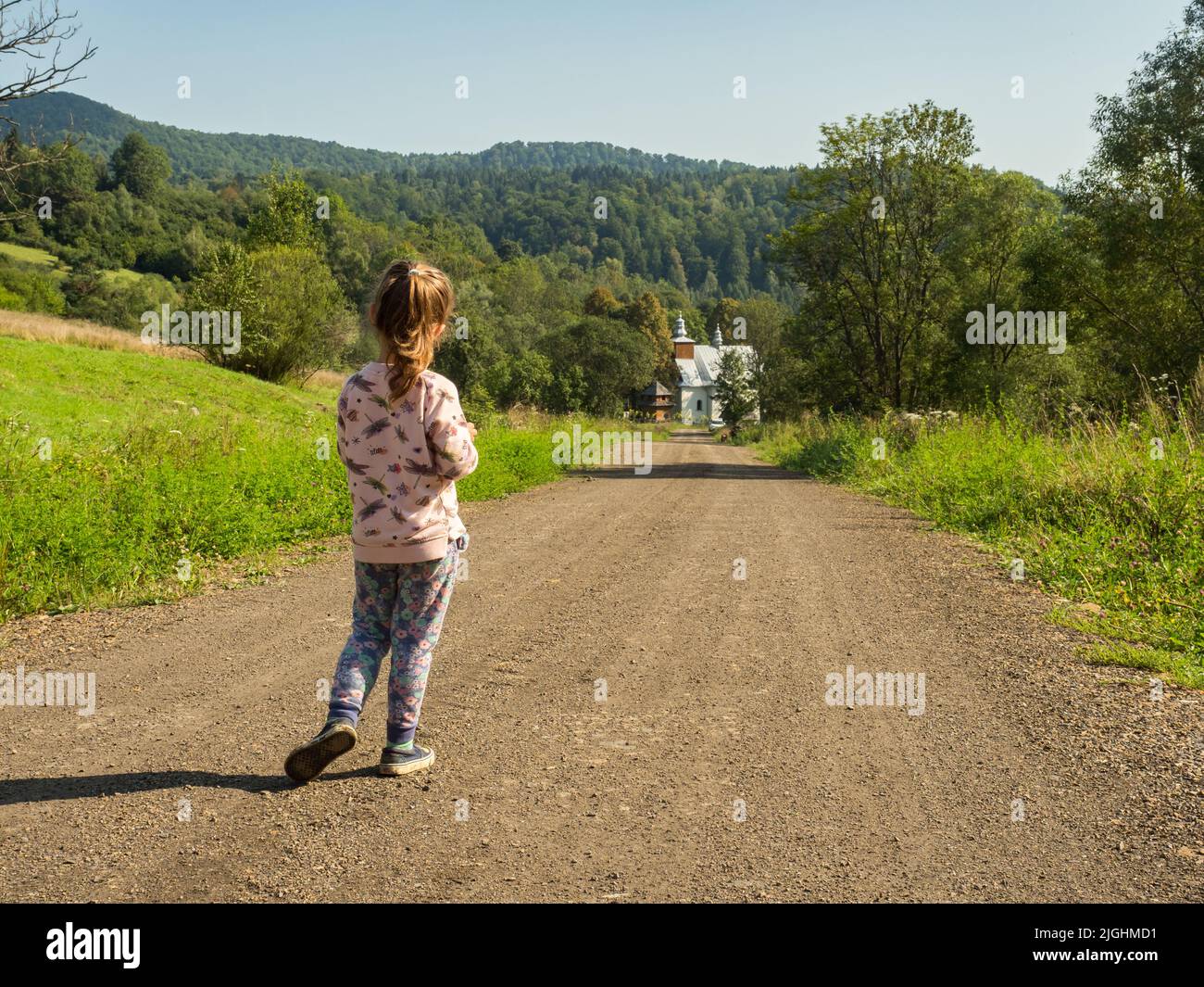 Łopienka, Poland-August 2018: Small girl on the trail to the Greek Catholic Church in Łopienka, Bieszczady, Europe Stock Photo