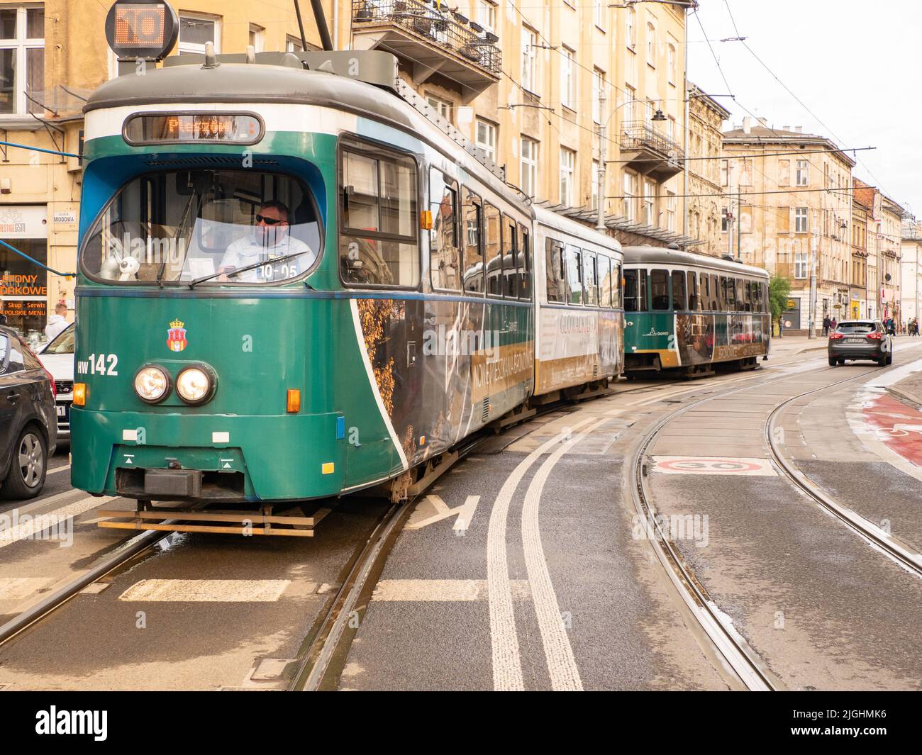 Krakow, Poland - May 2021: Green old tram on the historic street in Krakow, Poland. Europe Stock Photo