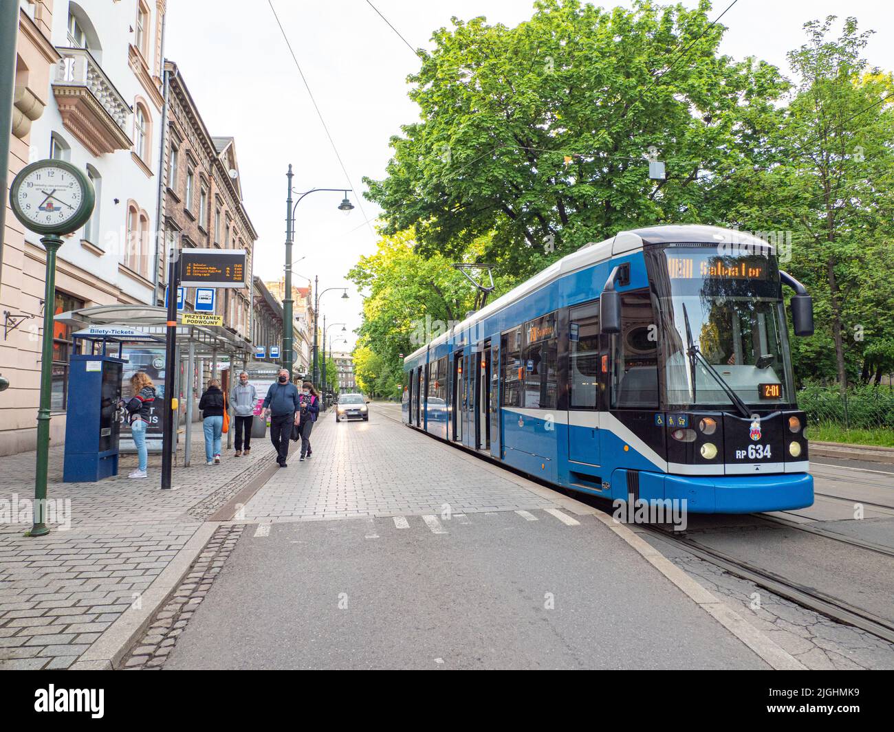 Krakow, Poland - May 2021: Blue tram on the historic street in Krakow, Poland. Europe Stock Photo