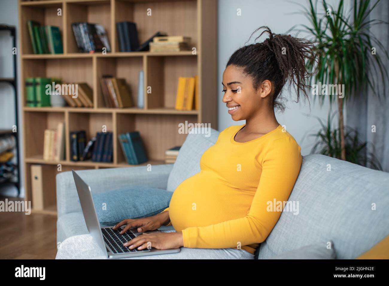 Cheerful millennial pregnant african american lady with big belly ...