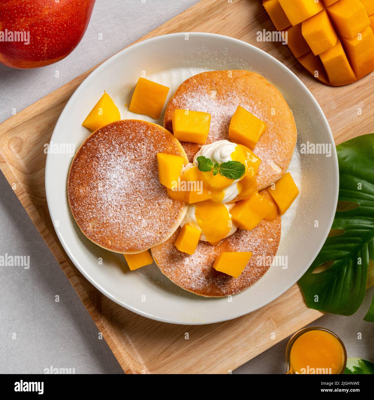 Delicious Japanese souffle pancake with dice mango fruit pulps and jam