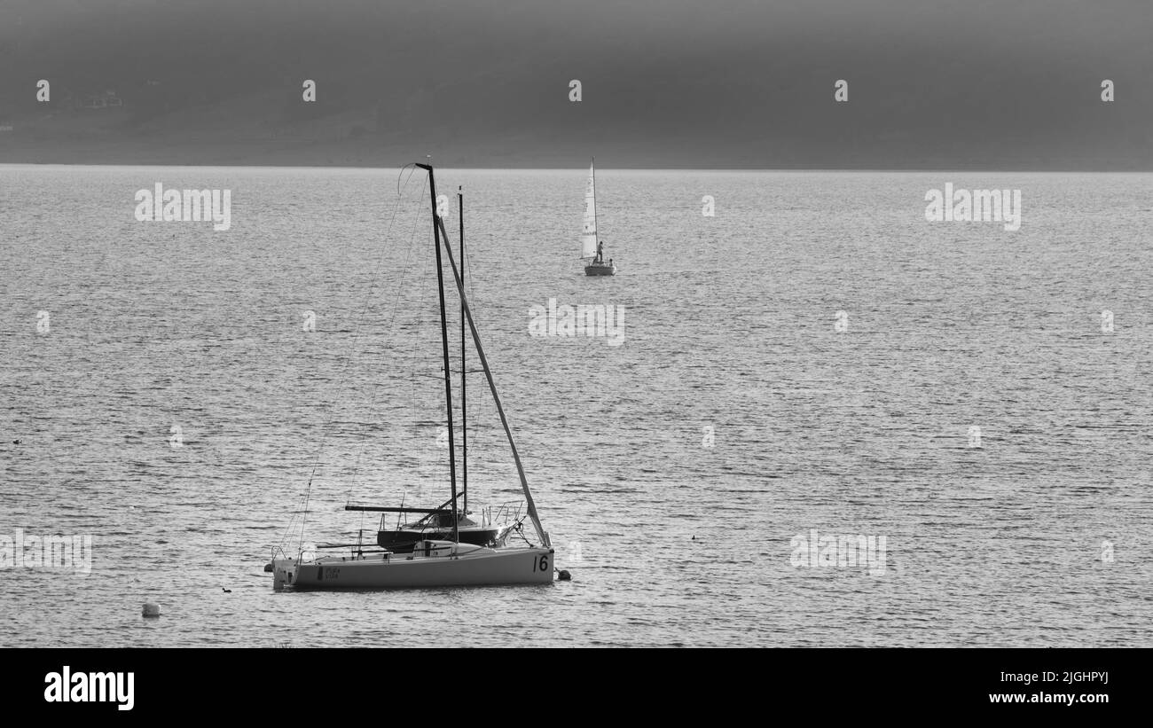 An aerial view of boats floating on sea in black and white Stock Photo