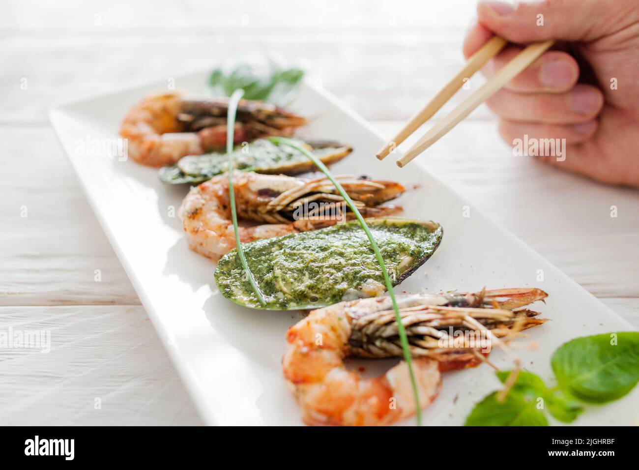 Seafood eating with chopsticks, close-up Stock Photo