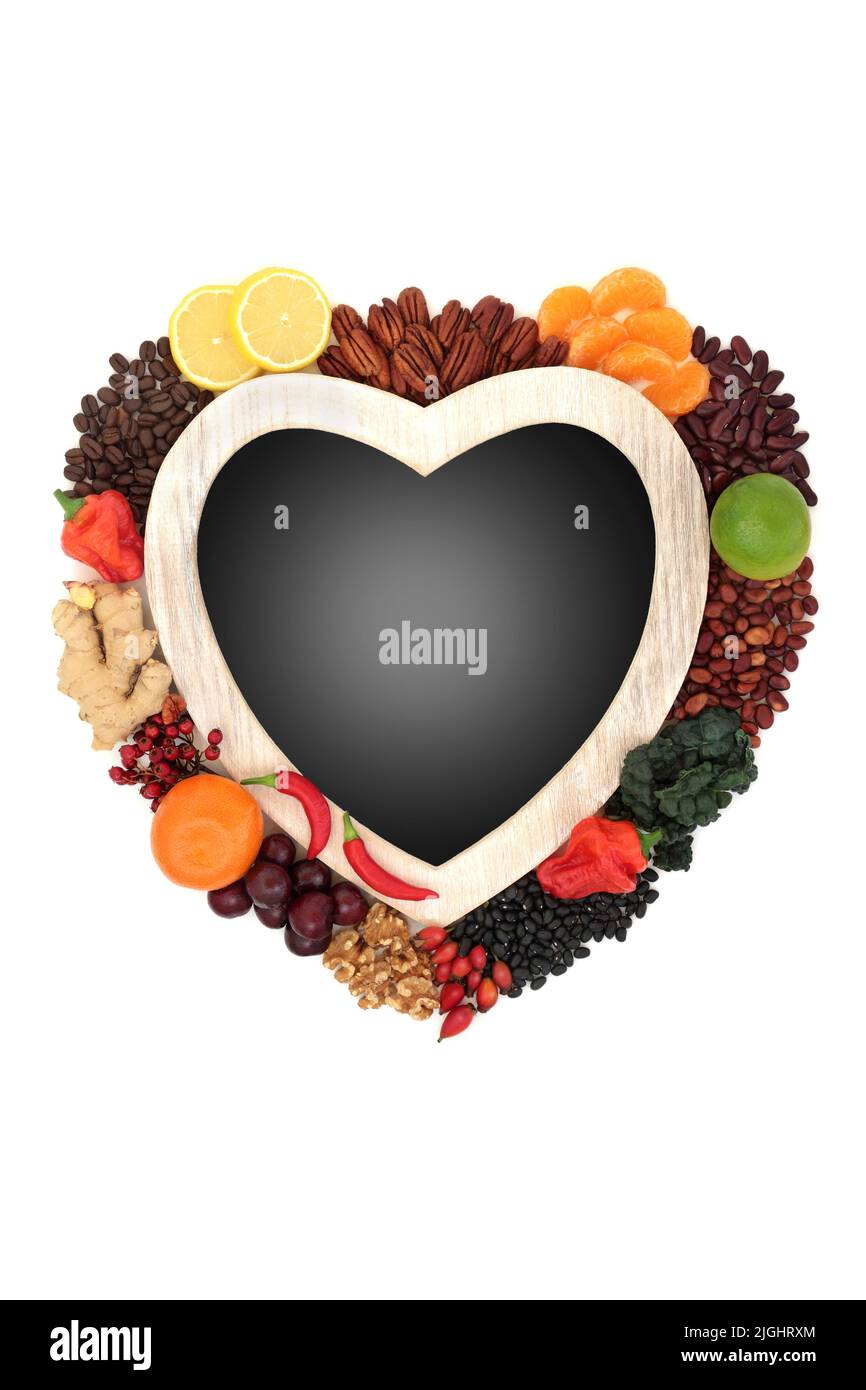 Vegan natural health food diet with heart shaped frame. High in flavonoids, polyphenols, fibre, anthocyanins, bioflavonoids, lycopene, antioxidants. O Stock Photo