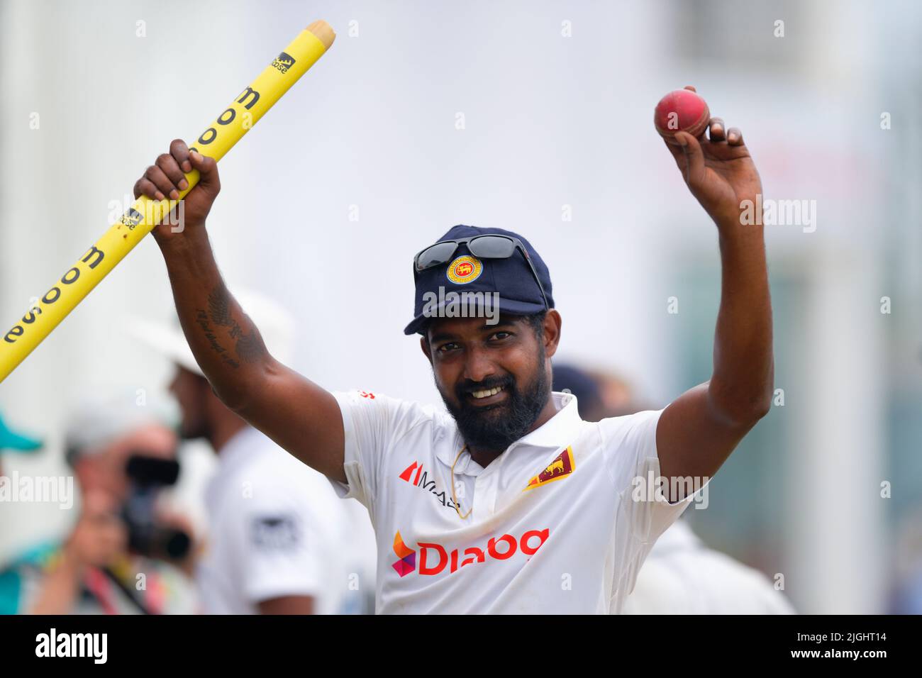 Galle, Sri Lanka. 11th July 2022. Sri Lanka bowler Prabath Jayasuriya raises the ball and a stump to the crowd at the end of the innings after taking 6 wickets during the 4th day of the 2nd test cricket match between Sri Lanka vs Australia at the Galle International Cricket Stadium in Galle on 11th July, 2022. Viraj Kothalwala/Alamy Live News Stock Photo