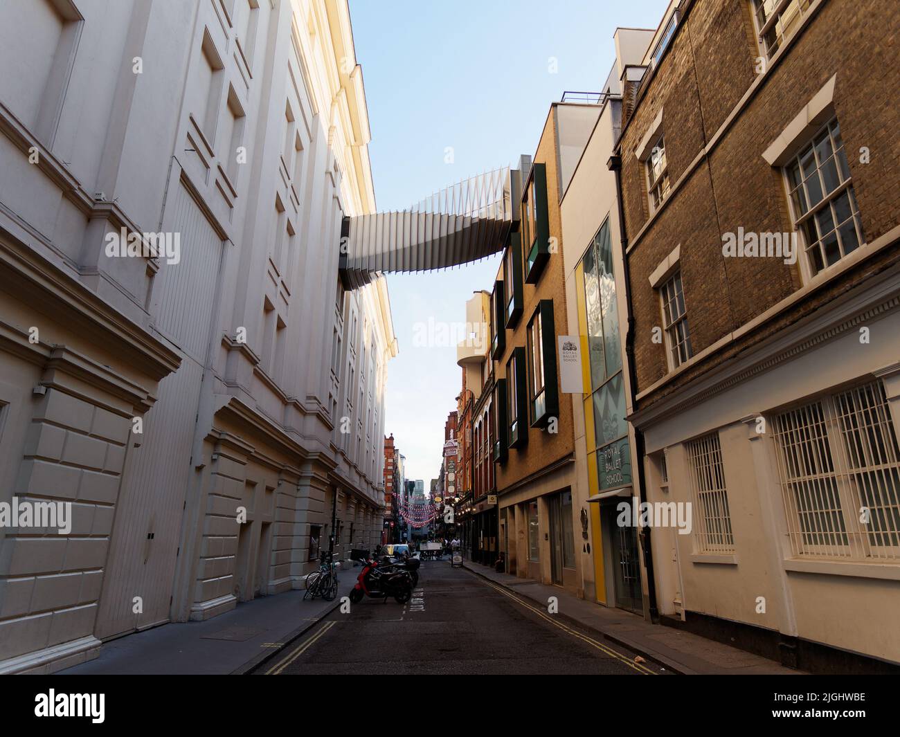London, Greater London, England, June 15 2022: Floral Street with the Royal Ballet School Bridge of Aspiration featuring a twisting design. Stock Photo