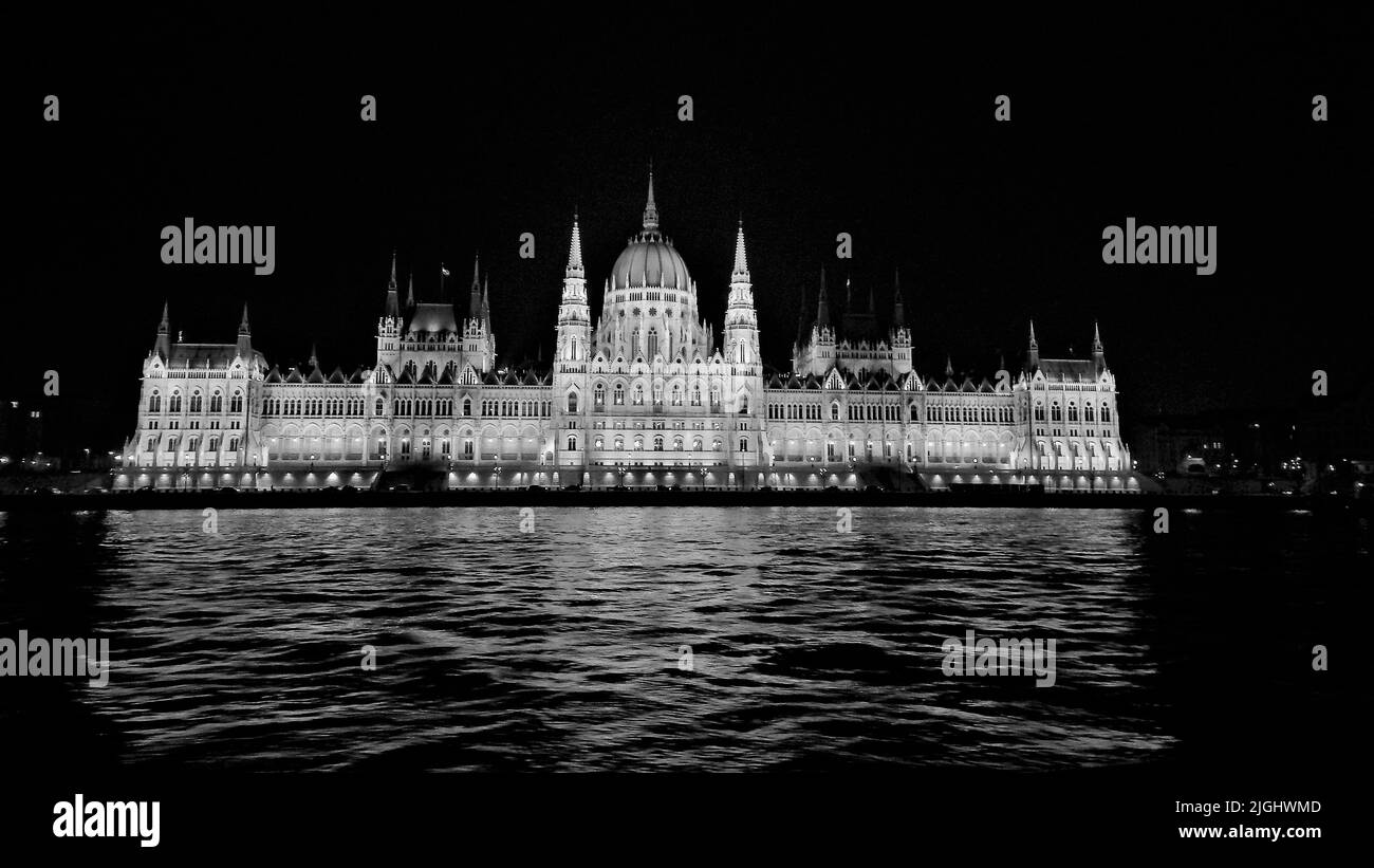 A grayscale of the Hungarian Parliament Building on the riverbank of the Danube Stock Photo