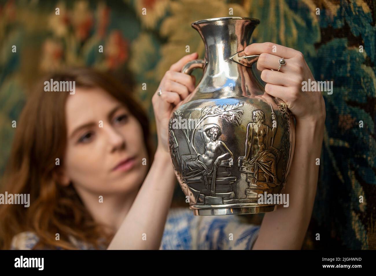 London, UK.  11 July 2022. A staff member presents 'A silver copy of the Portland Vase' by Charles Reily & George Storer (Est. £4,000 - £6,000) at a preview of Bonhams’ works from the Grand Tour sale at their New Bond Street gallery.  The sale celebrates the 18th Century Grand Tour partaken by European royalty, aristocracy and landed gentry and its influence on European taste, where almost every such tourist would return home with prints or sculpture or paintings.  The works of art auctioned on 14 July.  Credit: Stephen Chung / Alamy Live News Stock Photo
