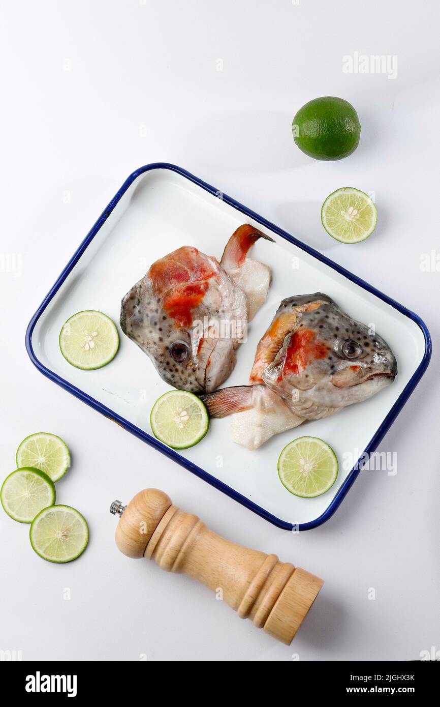 Top View Raw Salmon Head on Enamel Tray with Lime, Ready to Cook Stock