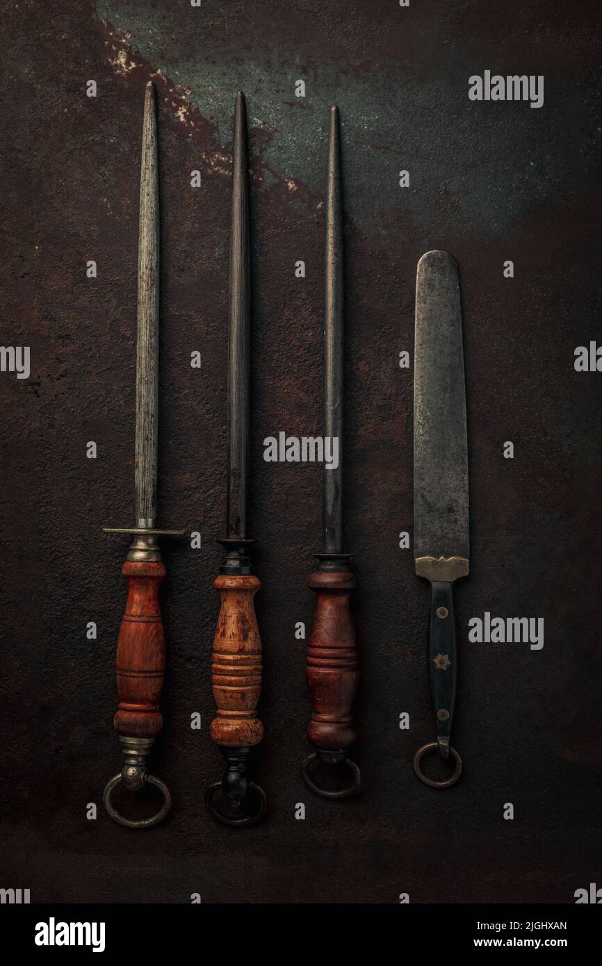set of rusty vintage knife sharpeners with wooden handle and carbon ...