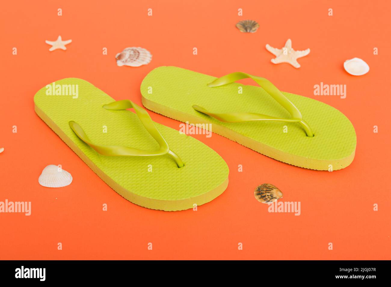 Beach accessories. Flip flops and starfish on colored background. Top view Mock up with copy space. Stock Photo
