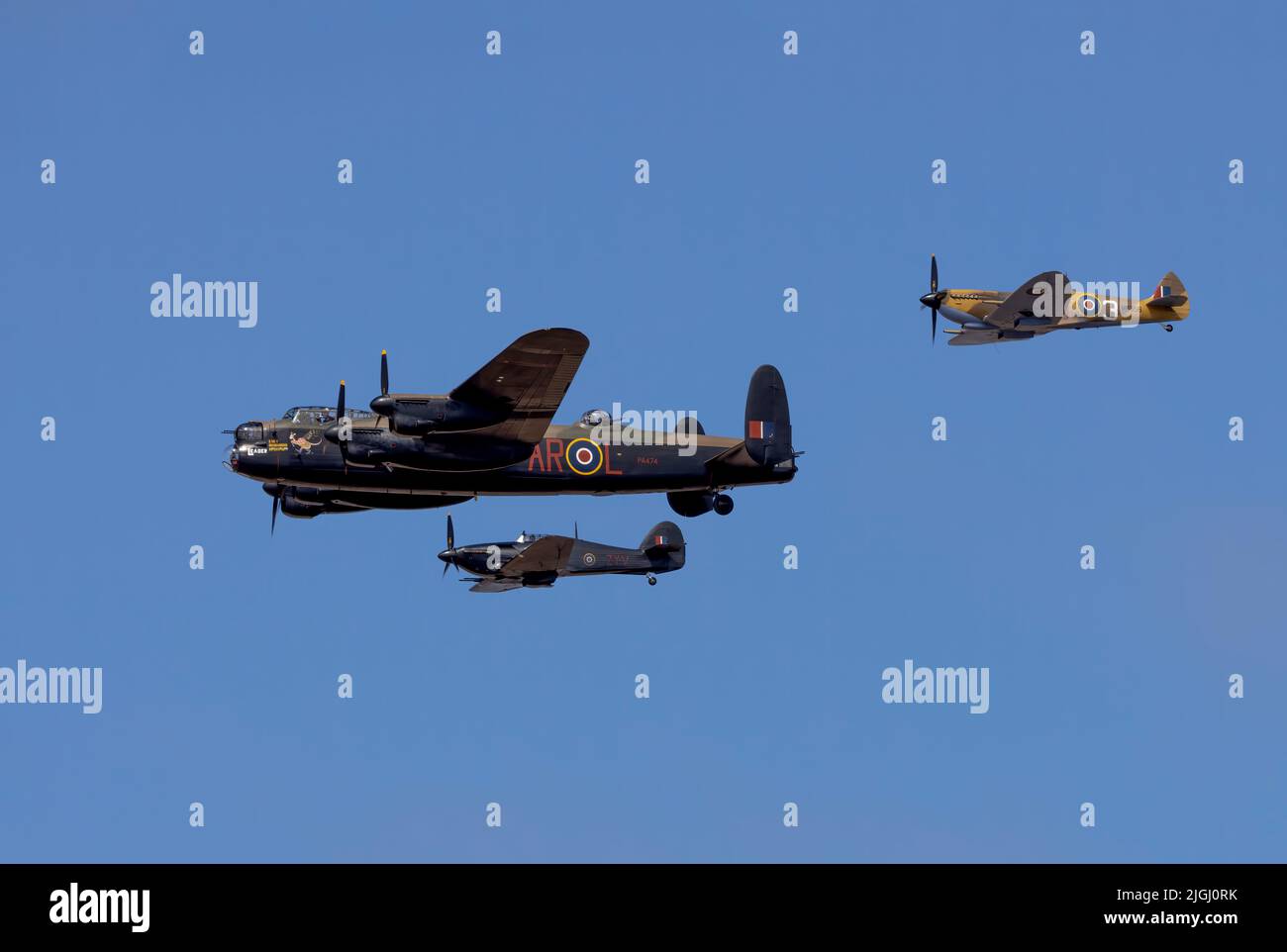 An RAF Hurricane and Spitfire flank a Lancaster bomber forming the Battle of Britain Memorial Flight displaying at Southport Air Show, Merseyside, UK Stock Photo