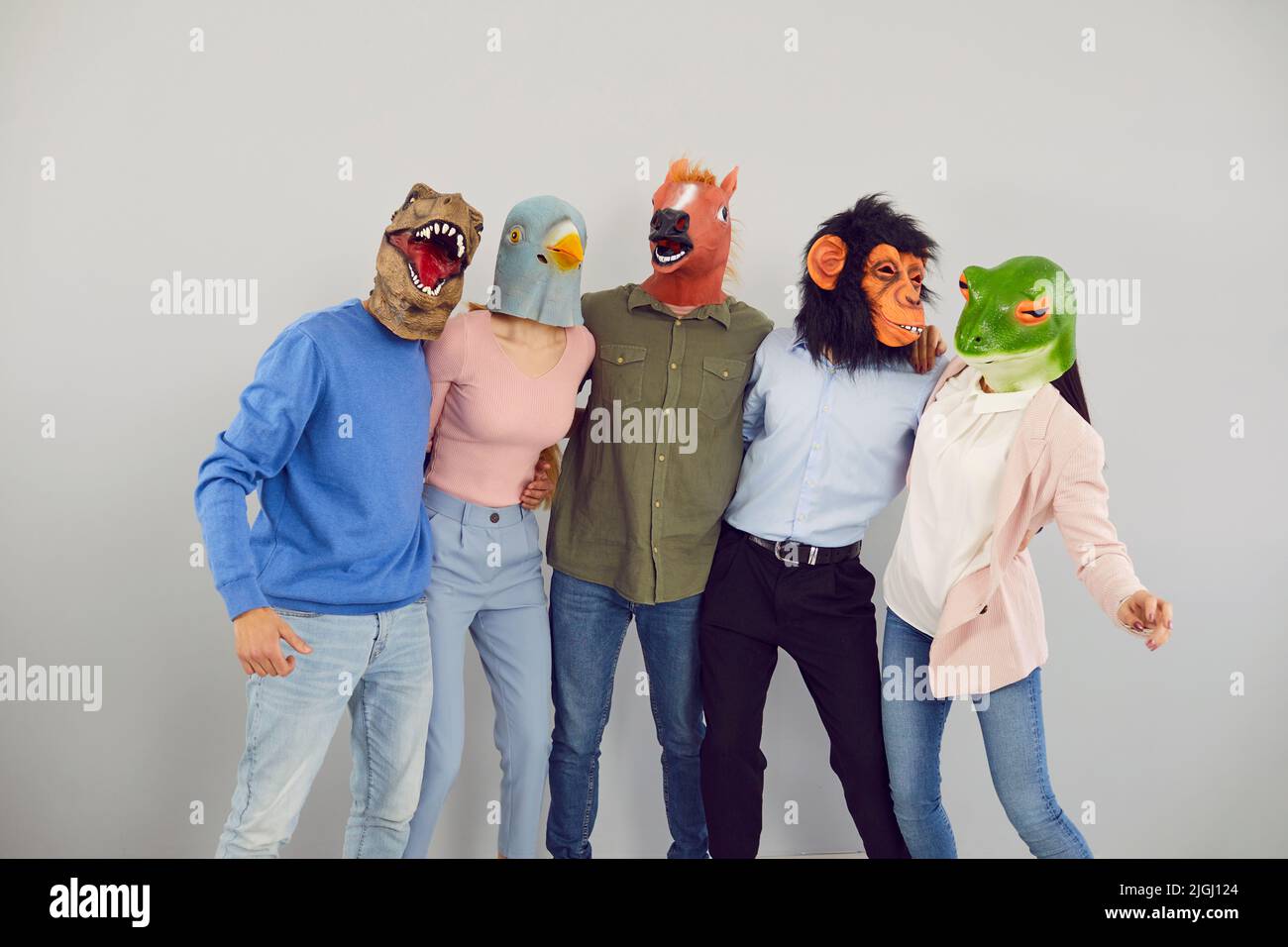 Funny diverse people in animal masks hug Stock Photo
