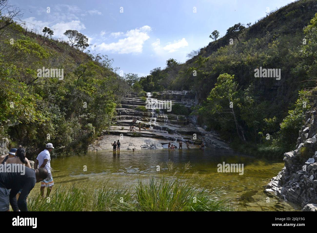 Waterfall in the dry season in the National Park, tourist site, bottom-up view, with vegetation on the side, Brazil, South America, several tourists a Stock Photo