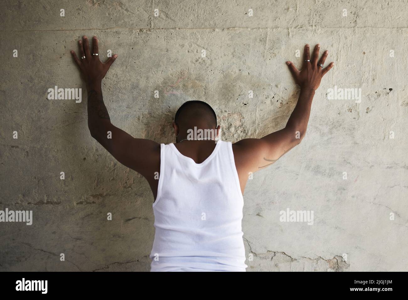 Hands Up And Spread Em Rearview Shot Of A Man Leaning Against An Urban Hands Up And Spread Em Rearview Shot Of A Man Leaning Against An Urban Wall With His Hands Up 2JGJ1JM