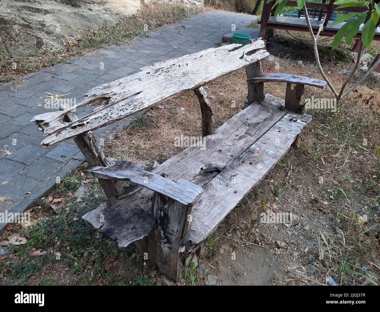 Front view in full length of a weathered wooden bench at a river in ...